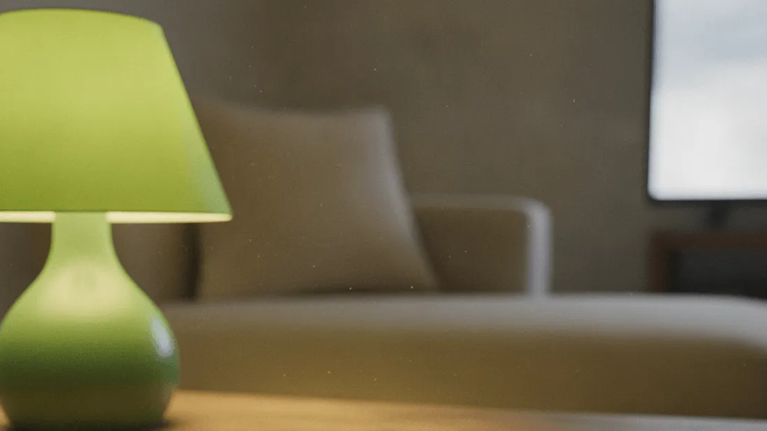 Two remotes and a notepad with circled numbers sit on a coffee table, illuminated by a green lamp.