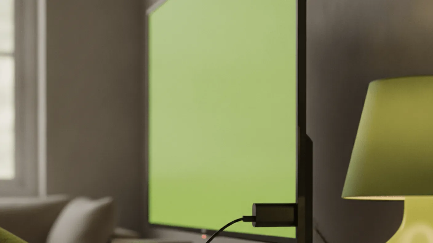A device is partially plugged into the back of a wall-mounted TV, with a cable trailing over a wooden console.